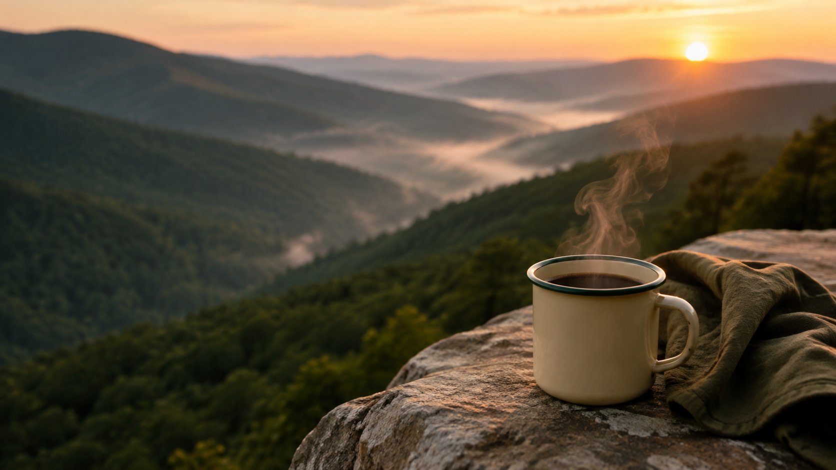 A camp mug and the first morning light over the Blue Ridge Mountains